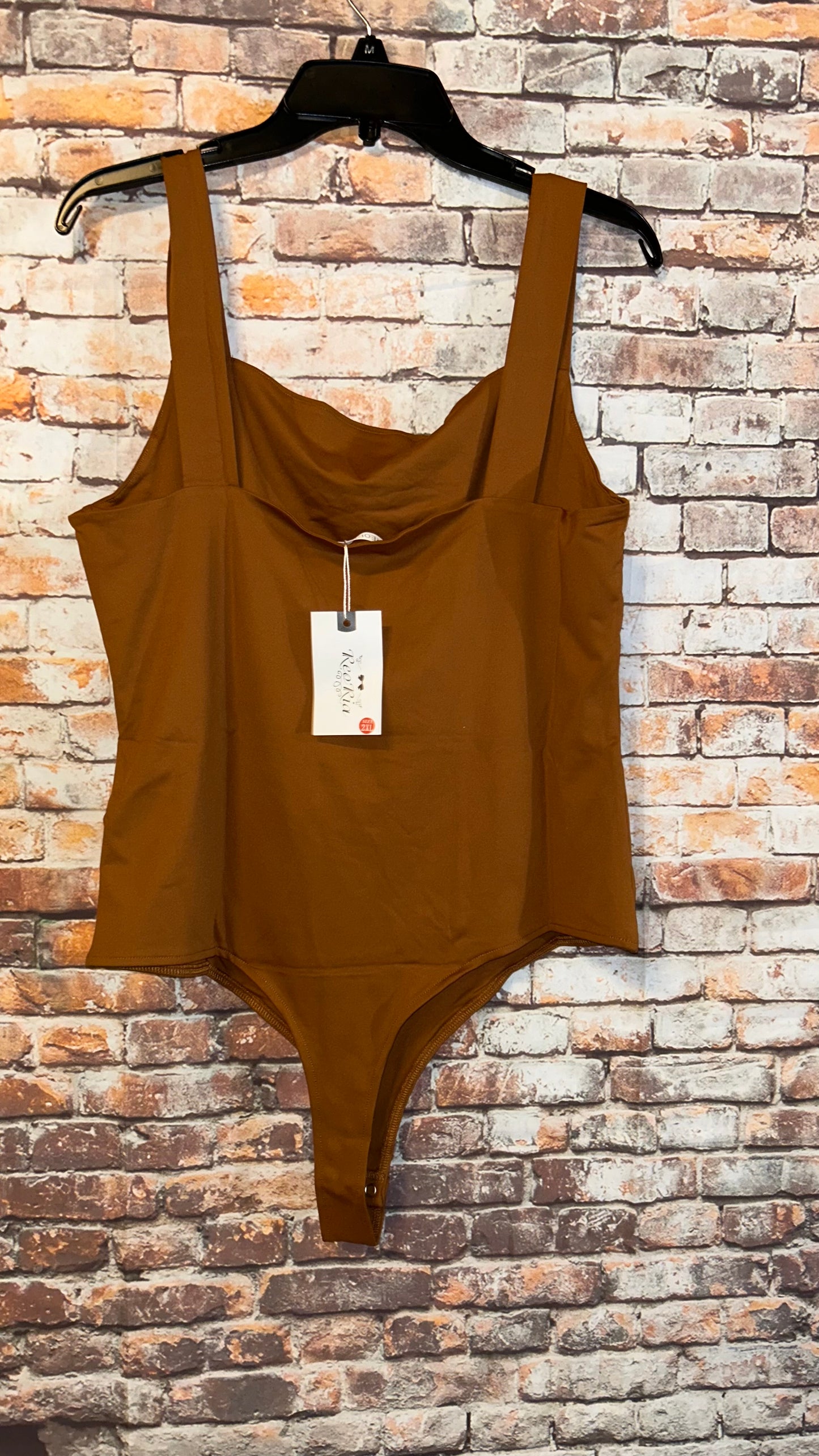 Women’s size 2x bodysuit fits smaller like a fitted 14-16 with stretch